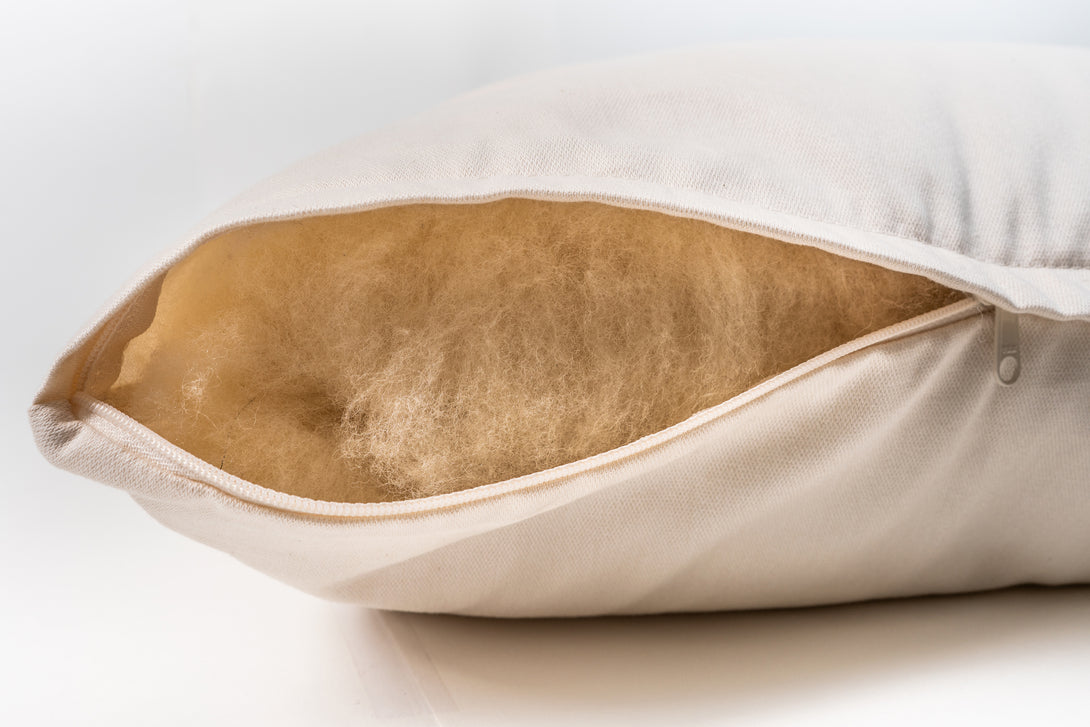 Natural wool pillow. Covered in a sateen fabric of organic cotton fibers.