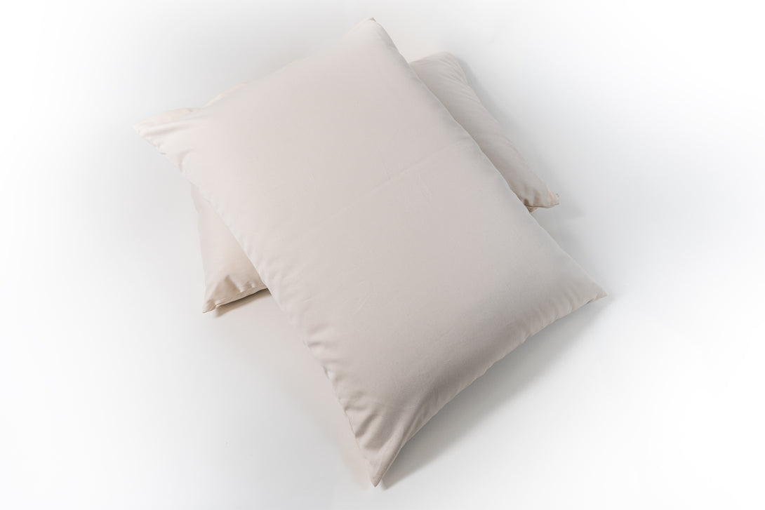 Natural wooly bolas pillow. Covered in a sateen fabric of organic cotton fibers.